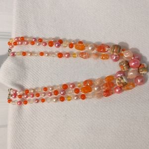 Vintage three strand glass necklace in pink orange and yellow.